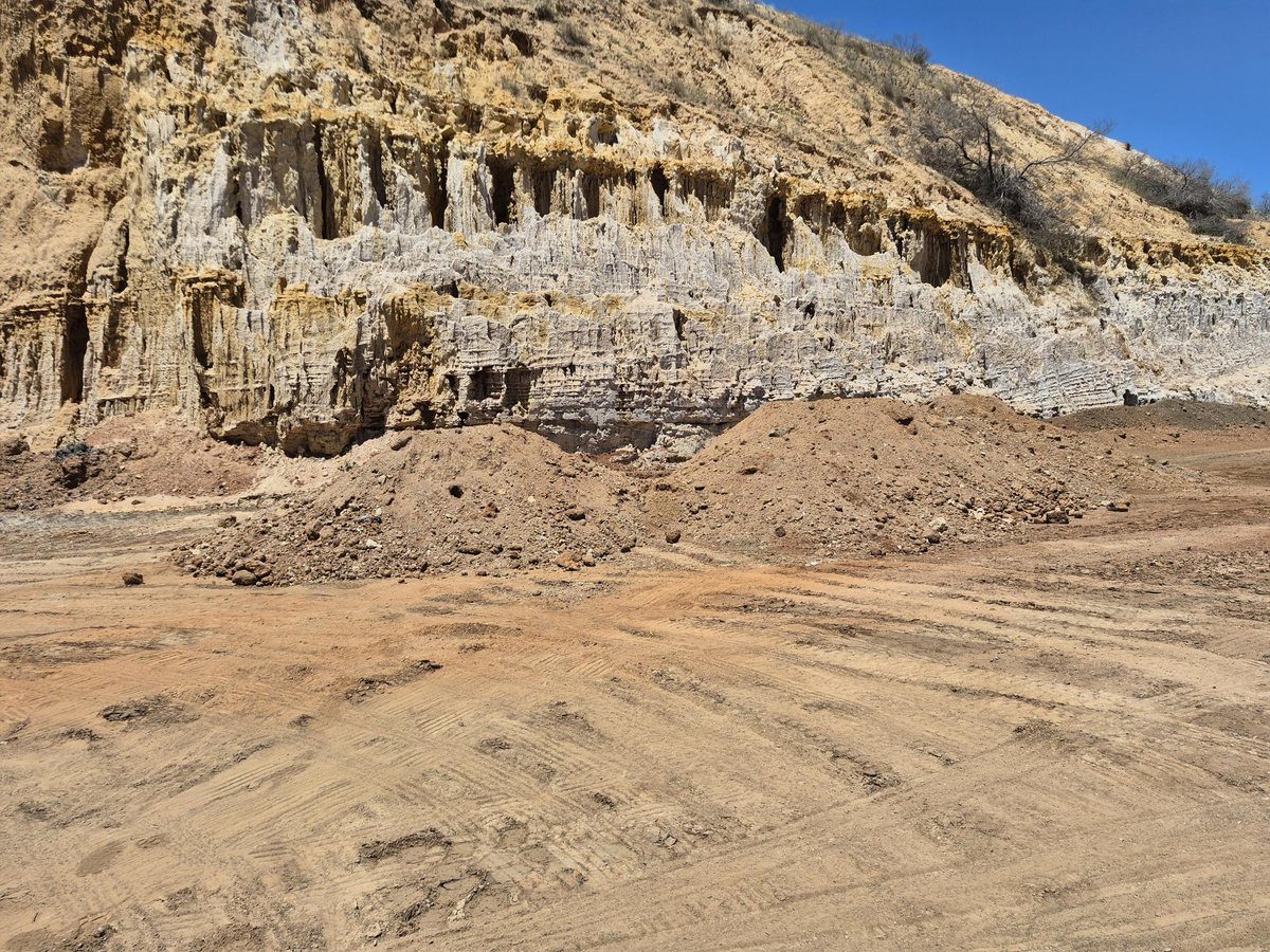 Stockpile at rehabilitation site, looking south — laminated limestone and clay geology in quarry face