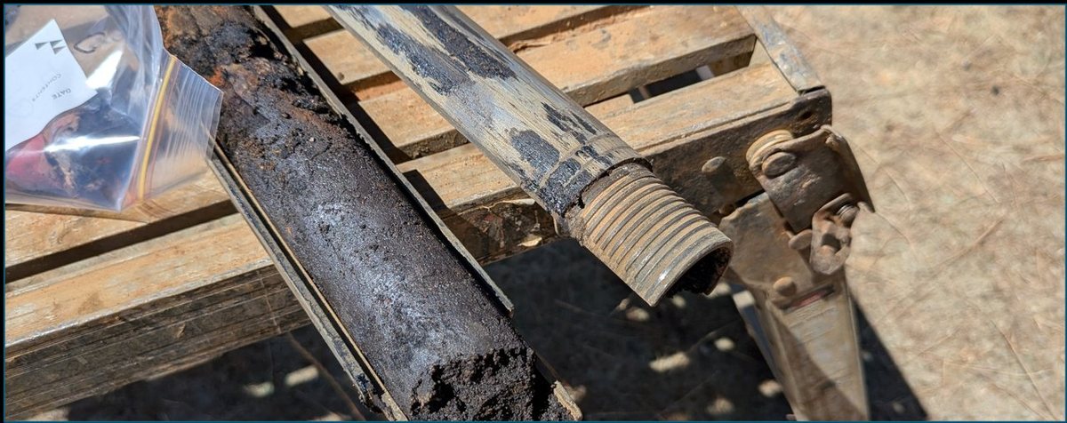 Dark coal tar-saturated core recovered from pughole fill — push tube drilling rig